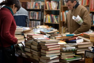 People looking at books on table