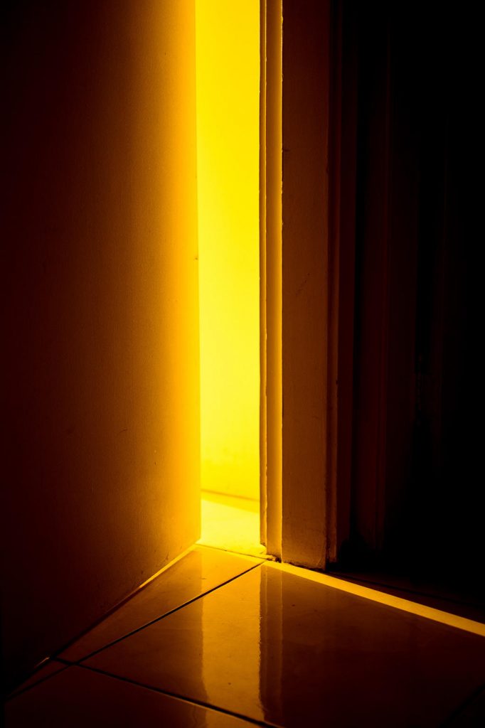 Bright light shines through a door